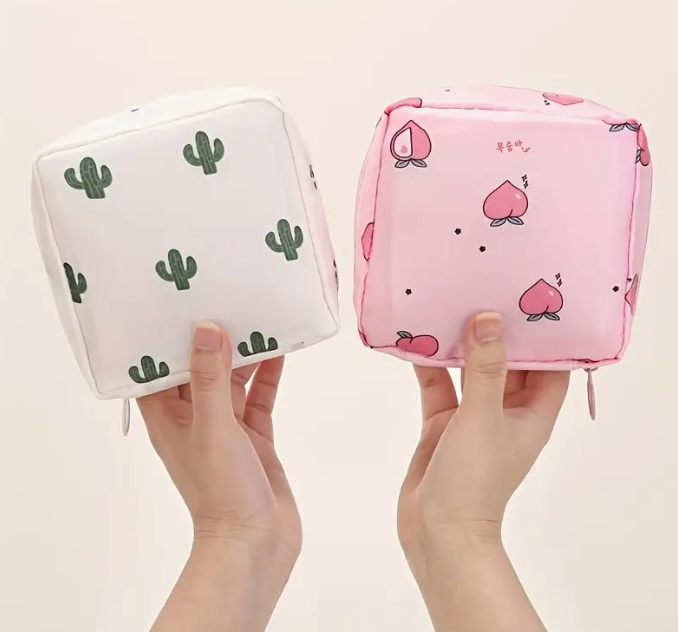 Pink pouches with peach pattern, held by hands against a plain background.
